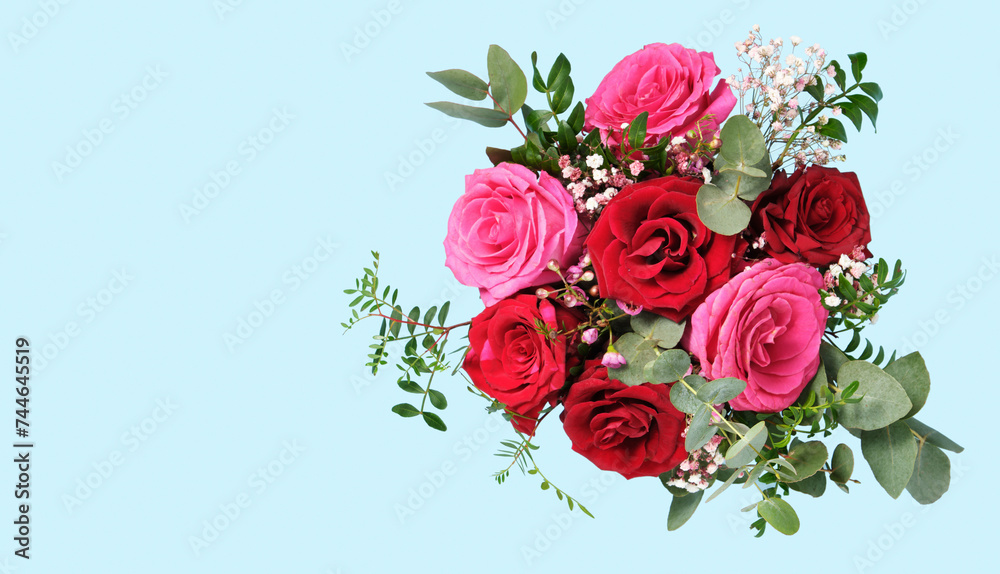 Horizontal banner with flatlay bouquet of pink and red roses on light blue background. Place for Your Text