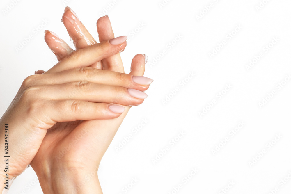 Female hands wipe running gel over the skin on a light background Female hands wipe running gel over the skin on a light background