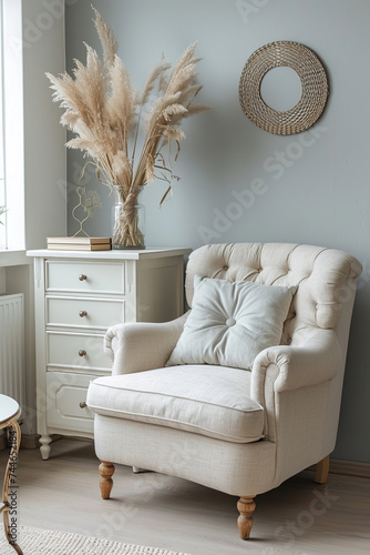modern armchair with pillow and chest drawers near light grey wall indoors