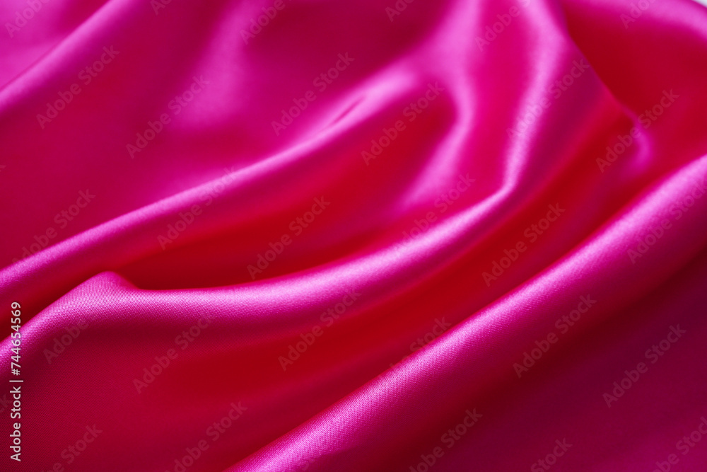 Obraz premium Pink silk or satin background, wavy, elegant and elegant. Close-up, background. Space for designblur or blurry
