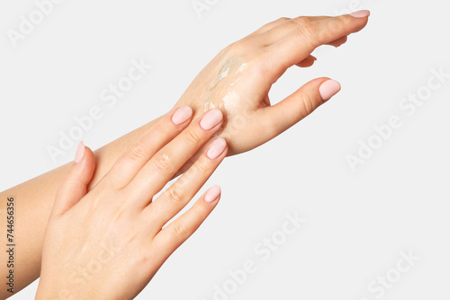 Women s hands in flowing gel  spreading over their hands. On a light background