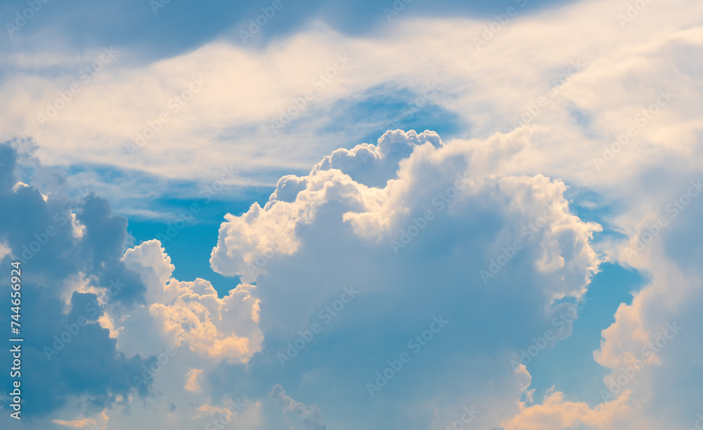 beautiful big clouds in the blue sky during sunset time