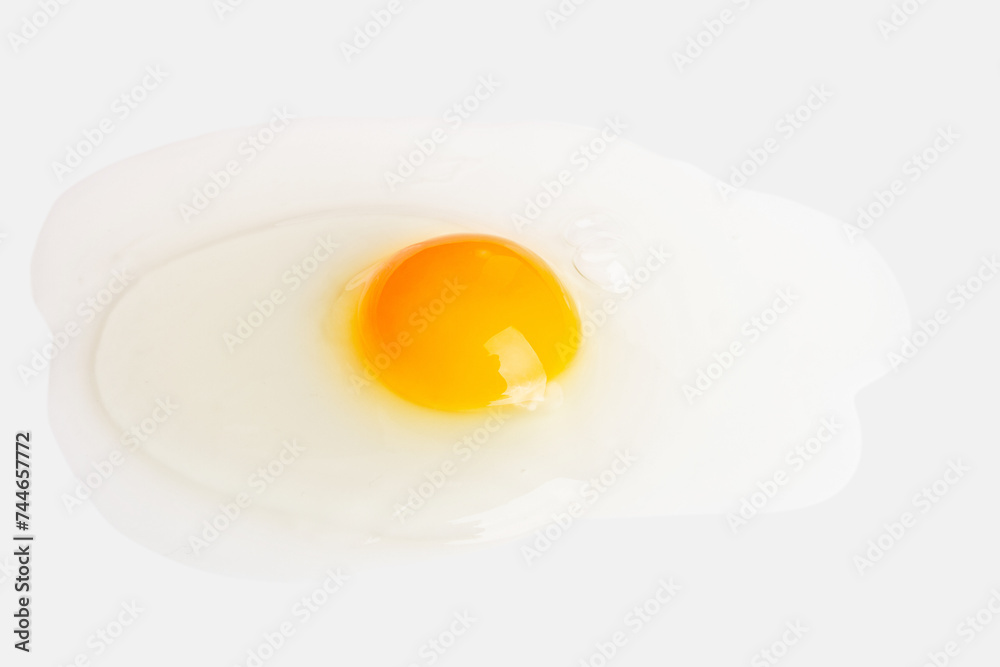 Broken spilled egg on a light background Broken spilled egg on a light background