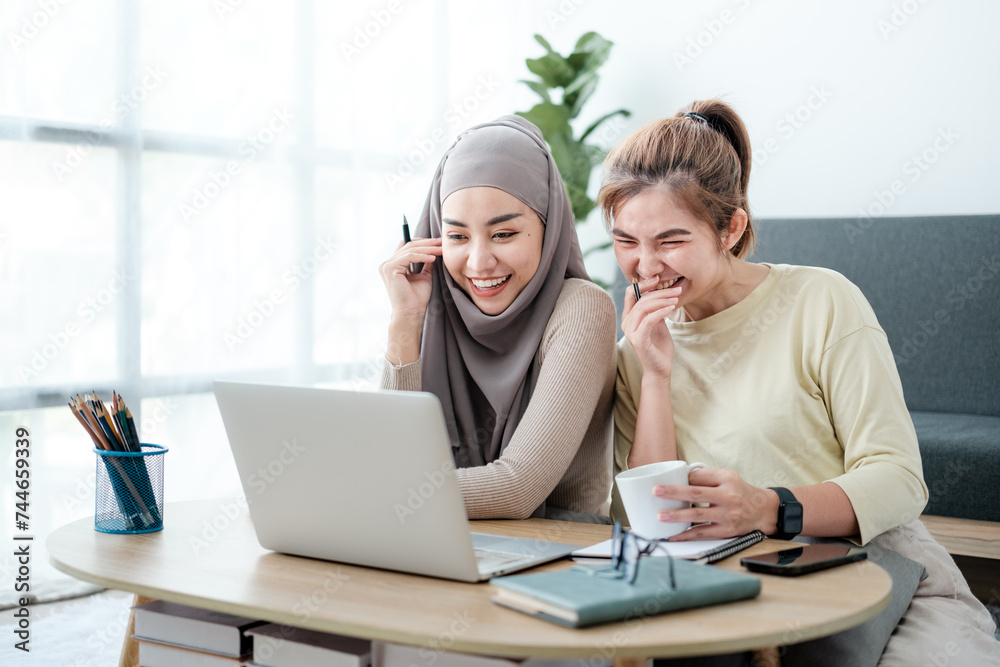 Happy beautiful diverse Asian women working and discussing together in the pantry area in co-working space, female students using laptop - notebook computer. Asian women colleague having a discussion. Happy beautiful diverse Asian women working and discussing together in the pantry area in co-working space, female students using laptop - notebook computer. Asian women colleague having a discussion.