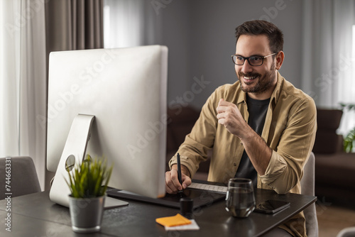 Portrait of a smiling man working at home on some new project