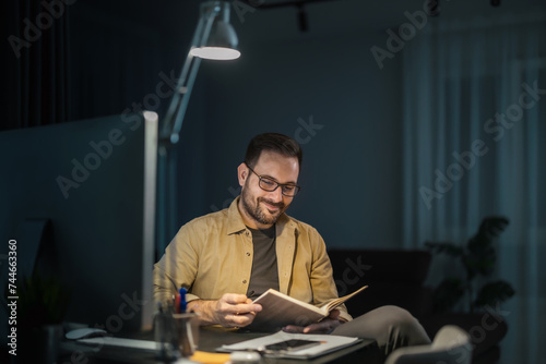 Portrait of a smiling man working at home on some new project