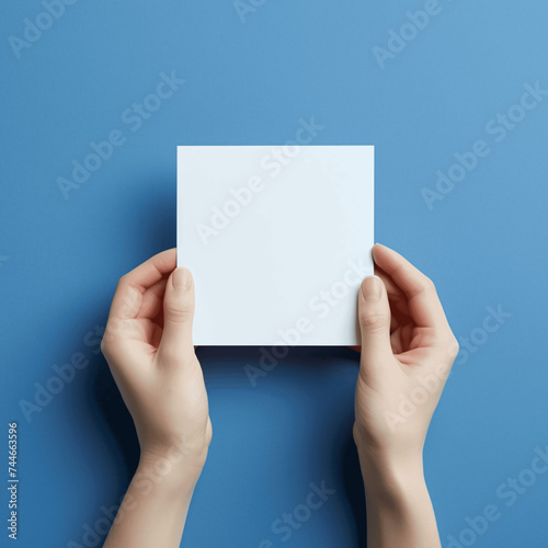 Flat Lay Image of Female Hands Holding Blank Note on Light Blue Background