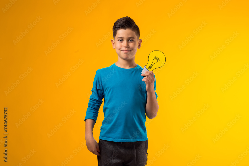 Child boy holding paper bulb. Success, motivation, winner, genius, idea concept Child boy holding paper bulb. Success, motivation, winner, genius, idea concept