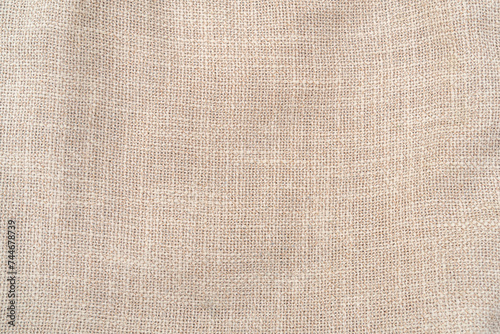 Hessian sackcloth woven jute burlap fabric cloth textile texture pattern background in brown beige aged color