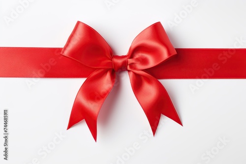 A beautifully tied red satin ribbon bow centered on a clean white background, symbolizing gift-giving and celebration.