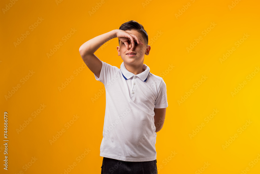 Kid boy closing nose with fingers because of bad smell