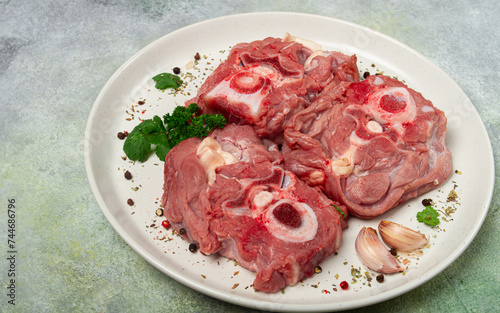 raw steak, calf's neck on the bone, fresh meat, on a white plate, top view, no people,