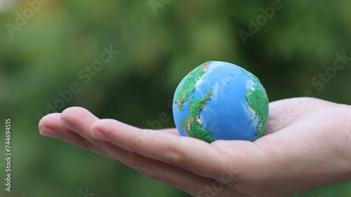 Environment Earth Day In the hands holding green earth on Bokeh green Background, Saving environment, and environmentally sustainable. Save Earth. Concept of the Environment World Earth Day