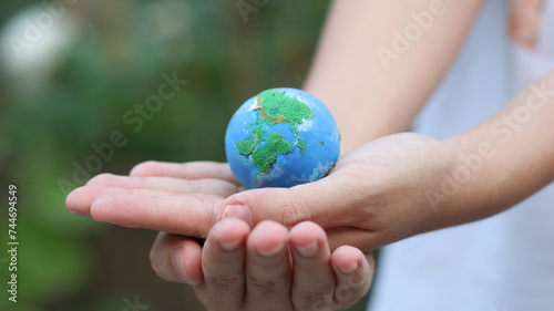 Environment Earth Day In the hands holding green earth on Bokeh green Background, Saving environment, and environmentally sustainable. Save Earth. Concept of the Environment World Earth Day