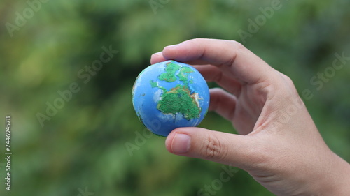 Environment Earth Day In the hands holding green earth on Bokeh green Background, Saving environment, and environmentally sustainable. Save Earth. Concept of the Environment World Earth Day