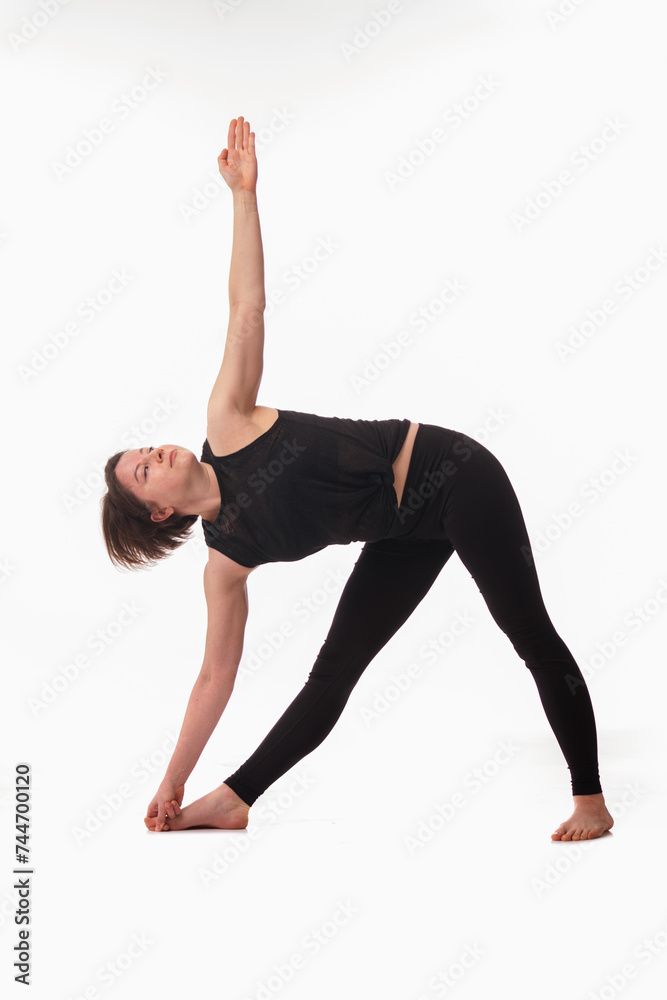 Triangle Pose Yoga (Utthita Trikonasana), Ashtanga yoga  Side view of woman wearing sportswear doing Yoga exercise against white background.