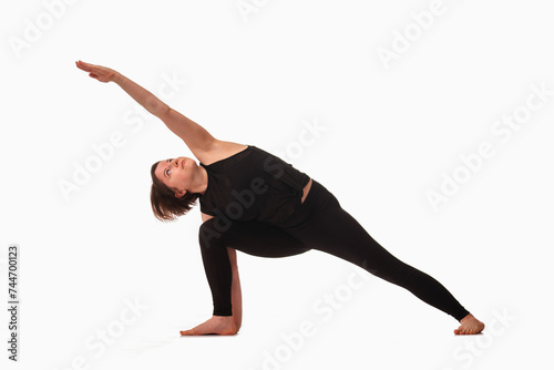 Angle Pose Yoga (Utthita Parsvakonasana), Ashtanga yoga  Side view of woman wearing sportswear doing Yoga exercise against white background.