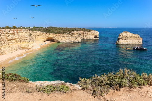 View to coastline with beautiful and sunny portuguese beach Praia da Marinha near Lagoa in summer, Algarve Portugal photo