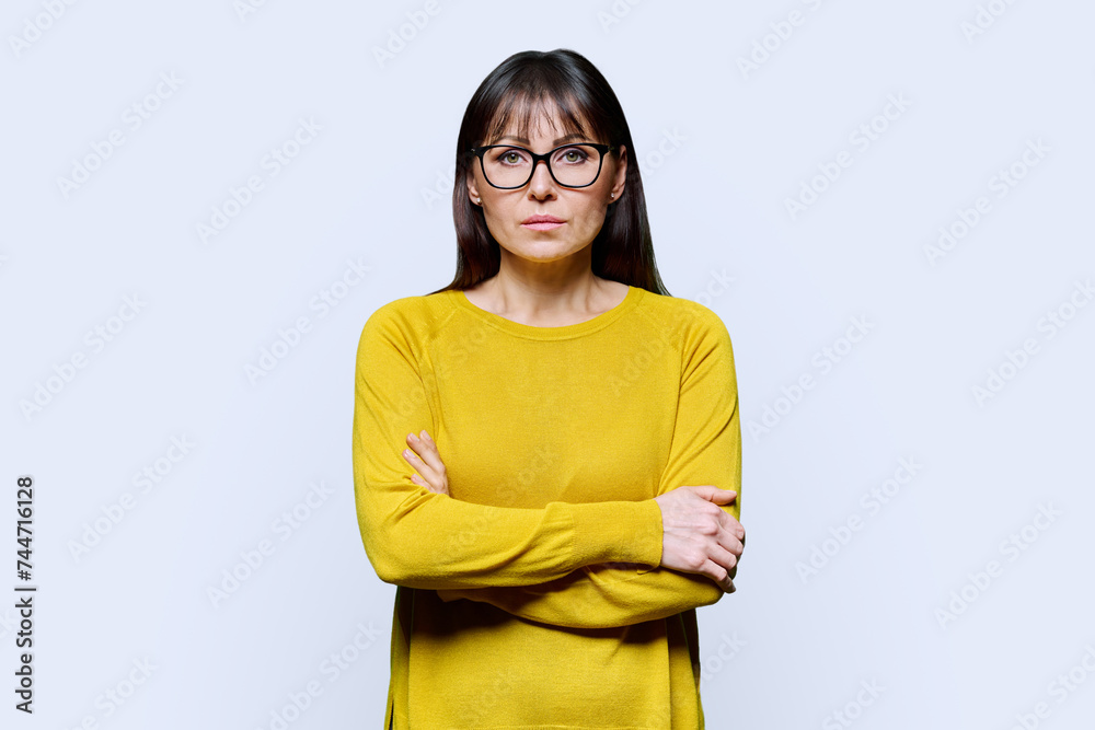 Portrait of serious mature confident woman on white studio background Portrait of serious mature confident woman on white studio background