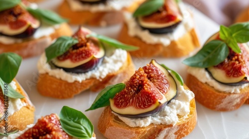a white plate topped with mini crostini covered in cheese and figs and topped with green leafy leaves.