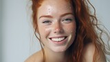 A woman with freckles on her face smiling. Suitable for beauty and lifestyle concepts