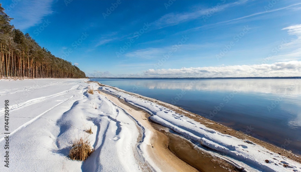 bright sunny winter day blue sky and snow covered coast a contrast view from the coast for the beginning of the vileysky reservoir in belarus