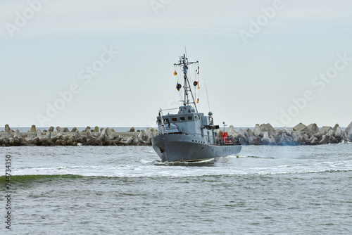 Russian warship armed with armament sails into sea toward military target to attack and destroy enemy, military ship performing strategic maneuver, Russian sea power deployment for tactical advantage