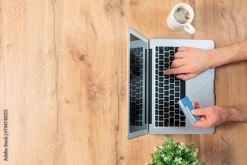 Top view of male hands making an online payment