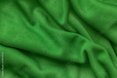 A crumpled green fabric background. Close up.