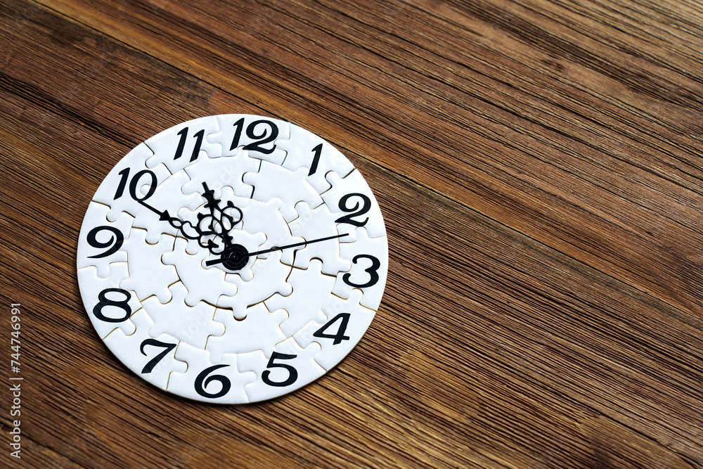 Timepiece Jigsaw Puzzle on a Wooden Background Timepiece Jigsaw Puzzle on a Wooden Background
