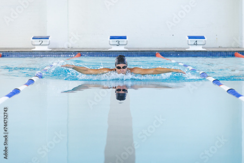 Caucasian female athlete swimmer swimming in a pool at a sports center photo