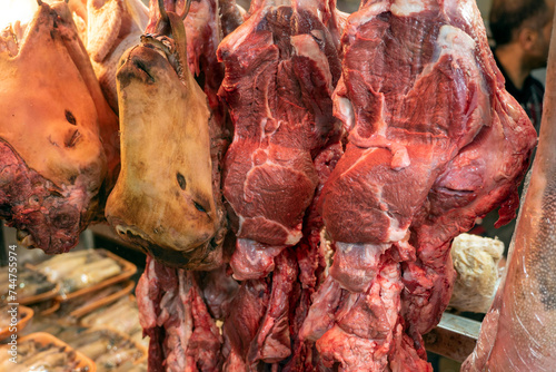 Sheep and cow heads, prepared to make trotters in a glass cabinet at the butcher shop photo