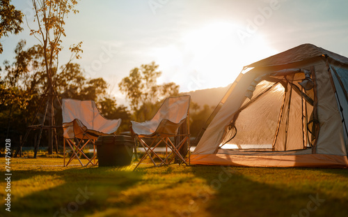 nature, tent, camp, landscape, summer, travel, adventure, mountain, sunset, camping. landscape is campground has campfire, tent, armchair near the lake with sunrise at mountains in the background.