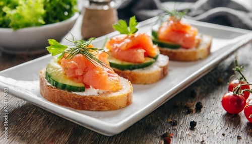 closeup of appetizers cooking toast with salmon in a white plate