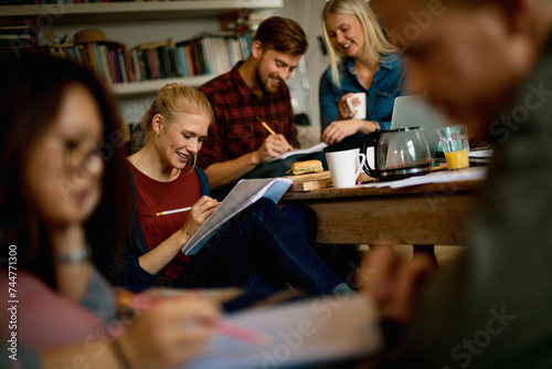 Diverse young people studying together at home