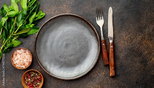 dark table setting empty ceramic plate and cutlery on stone background copy space for your text