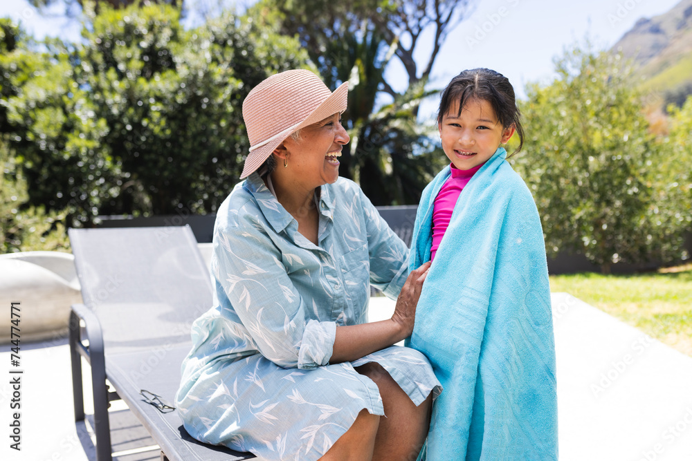 Biracial grandmother and granddaughter enjoy a sunny day outdoors Biracial grandmother and granddaughter enjoy a sunny day outdoors
