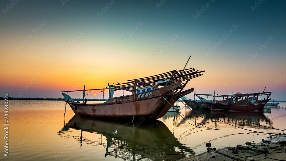 Boats on Dammam sea side with sunrise background view. Dammam, Saudi Arabia.