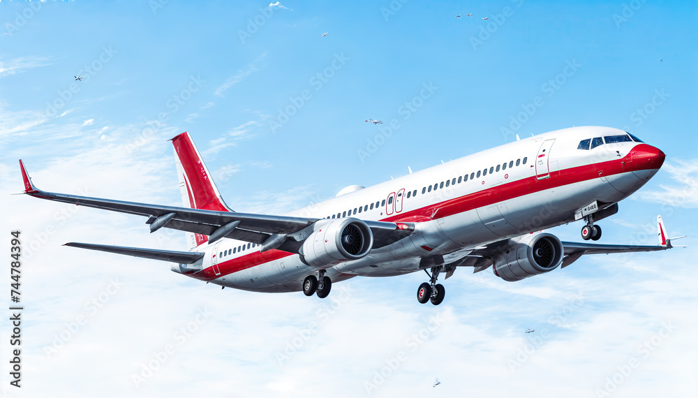  A large passenger airplane with red and white livery is flying in the sky