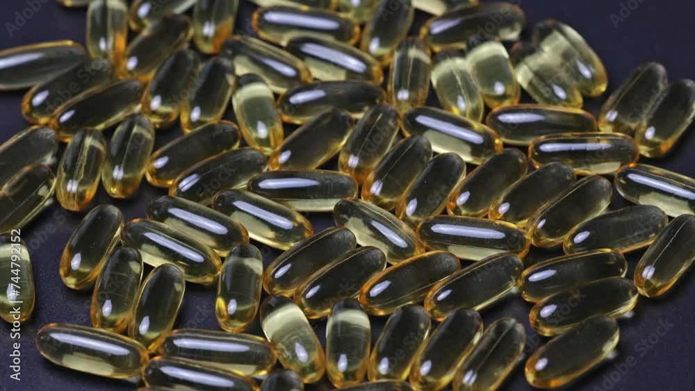 Omega 3 gold fish oil capsules rotation background. Close-up natural capsules with vitamin E, A. Omega 3 gold fish oil capsules rotation background. Close-up natural capsules with vitamin E, A.