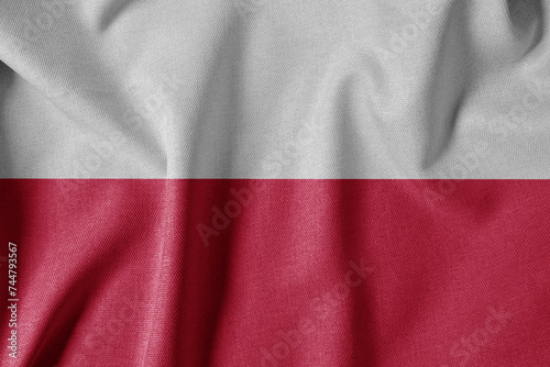 National Flag on Textured Fabric Background. Silk textured flag, realistic wave and flag look. PL Flag of Poland