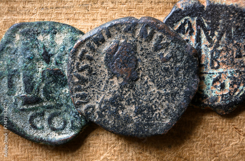 Ancient Byzantine follis coins on vintage background, top view, old worn bronze Roman Greek money close-up. Concept of Rome, Empire, Greece, texture, antique, artifact and history photo