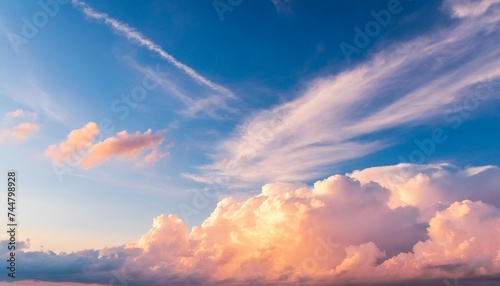 blue sky background with pale pink clouds at sunset
