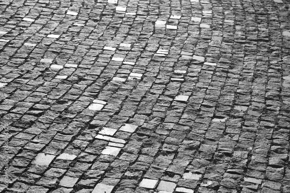 Background of stone floor texture. stone pavement in perspective. Old cobblestone road top aerial drone view. Old square cobble stone paving perspective background.