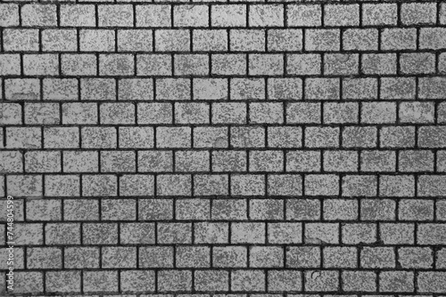 top view of grey Stone street road pavement texture. Grey brick wall background close up. Gray stone tile block background with horizontal texture of gray brick. brick surface.
