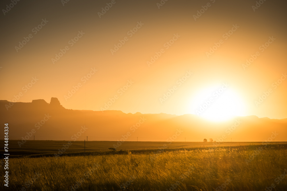 Sun setting over the distant hills in Drakensberg, South Africa