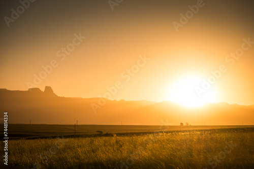Sun setting over the distant hills in Drakensberg, South Africa © Yann