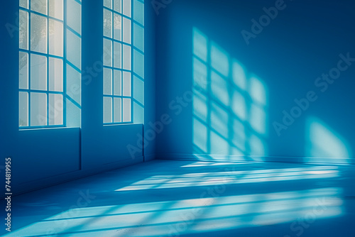Minimal abstract light blue background for product presentation. Shadow and light from windows on wall