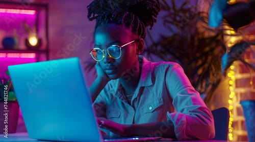 Portrait of a Multiethnic QA Engineer Working on Finding and Fixing Bugs in a Product or Program Software Code Before the Launch. Female Using Laptop Computer, Collaborating with Developers Online photo