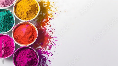 top view of colorful traditional holi powder in bowls isolated on white